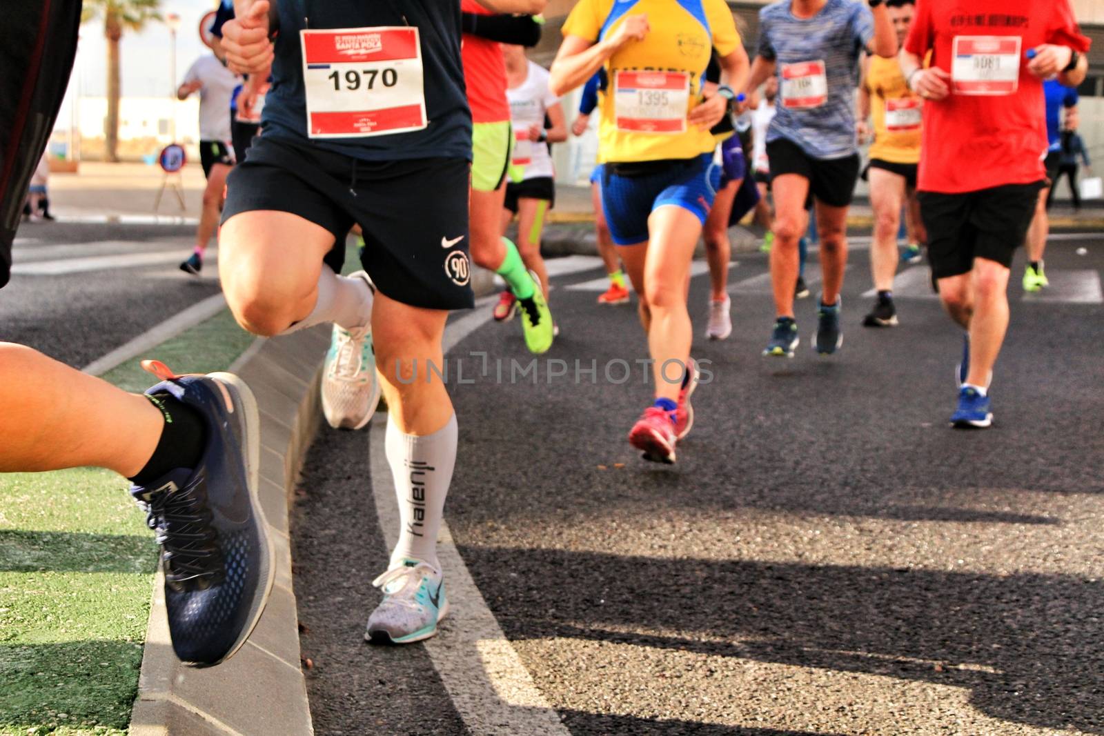 Santa Pola, Spain- January 20, 2019: Runners in the Half Marathon of the fishing village of Santa Pola, province of Alicante, on a sunny day in January