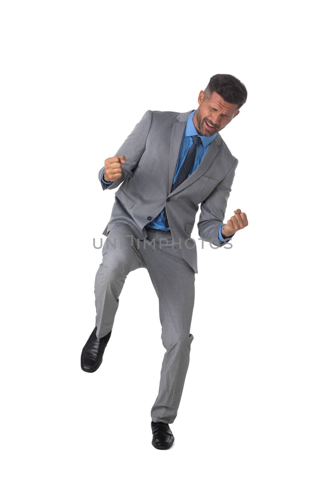 Young business man winner holding fists isolated on white background full length studio portrait