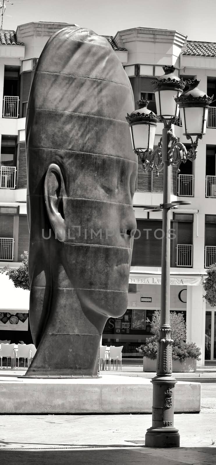 Elche, Alicante, Spain- July 20, 2020: Beautiful three-dimensional sculpture of a woman's face of the artist Jaume Plensa exhibited in the main square of Elche