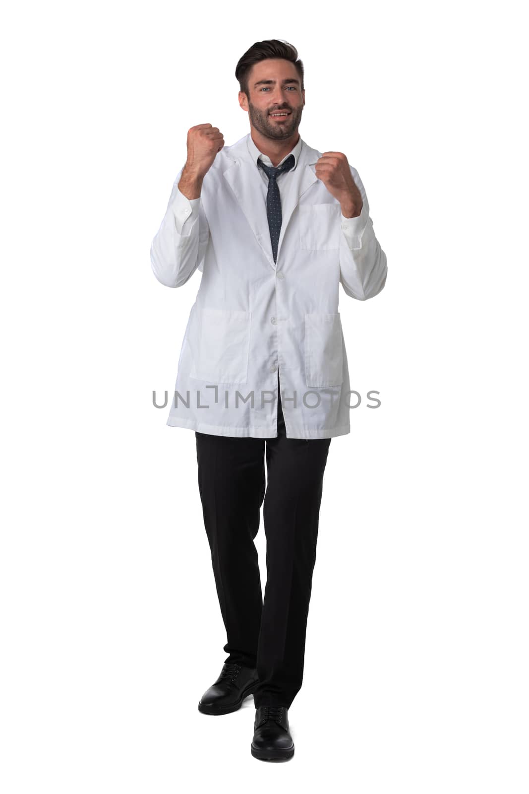 Young male medical doctor with stethoscope holding fists isolated on white background full length studio portrait