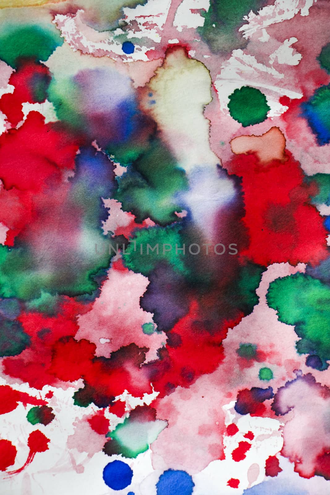 Ink drops on the paper, red, green and blue ink splashes background, painting and drawing