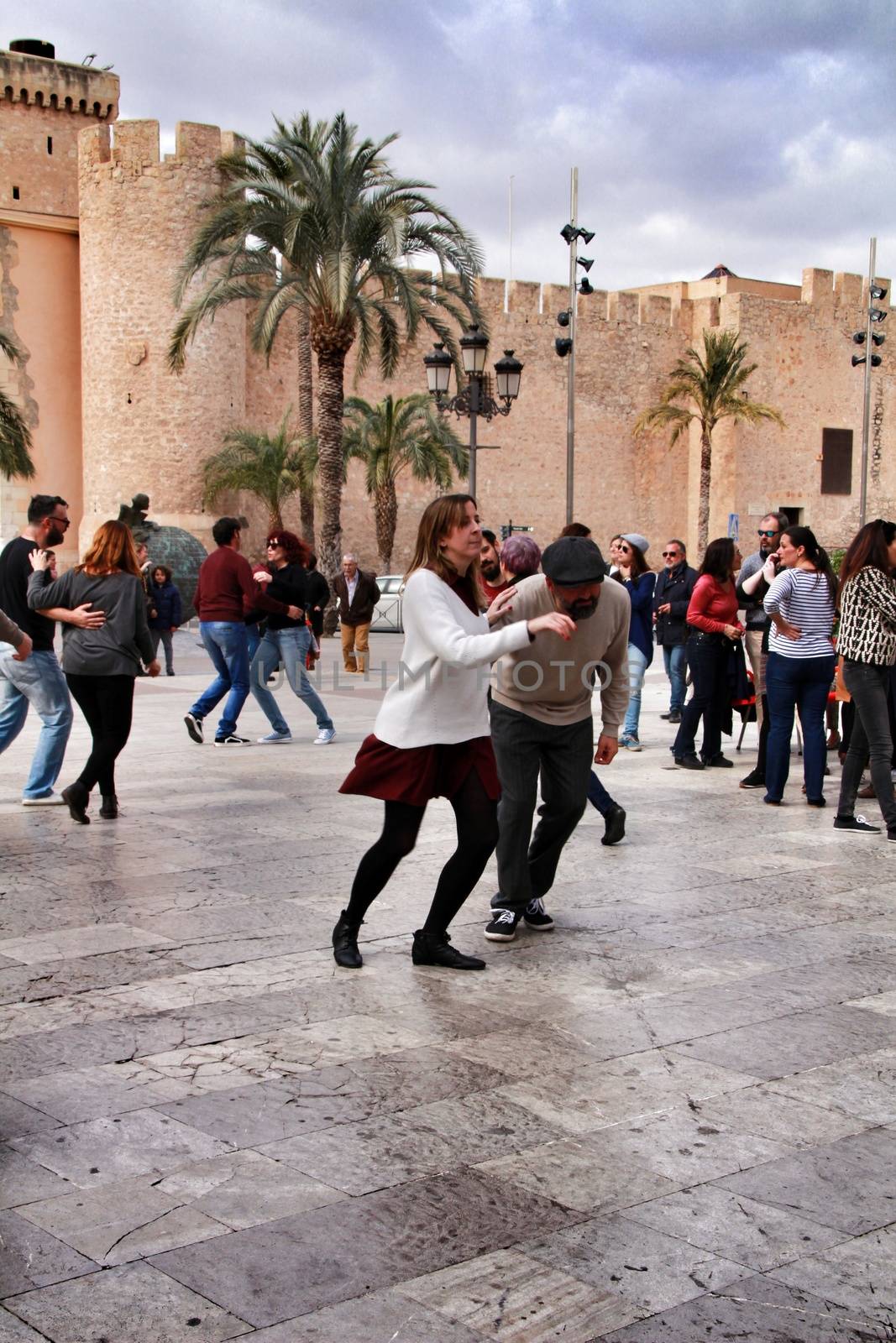 Elche, Alicante, Spain- February 19, 2019: People enjoying and dancing swing in the street in winter