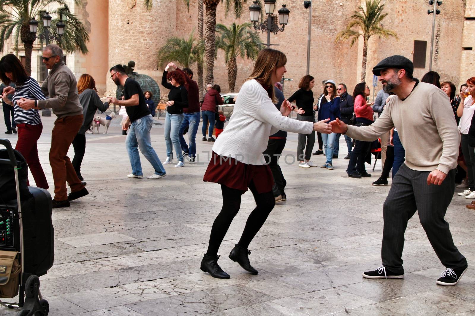 Elche, Alicante, Spain- February 19, 2019: People enjoying and dancing swing in the street in winter