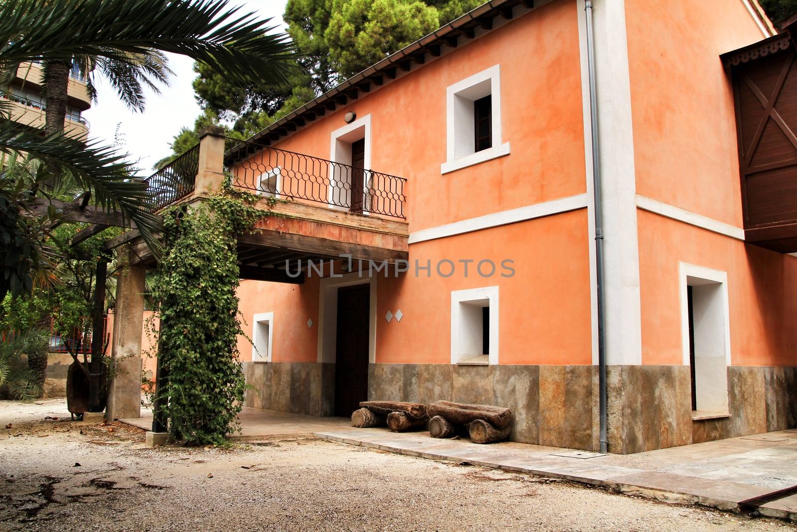 Elche, Spain- 30 August, 2020: Typical and colorful house in a palm orchard in Elche, Spain on a sunny day. Huerto de San Placido.