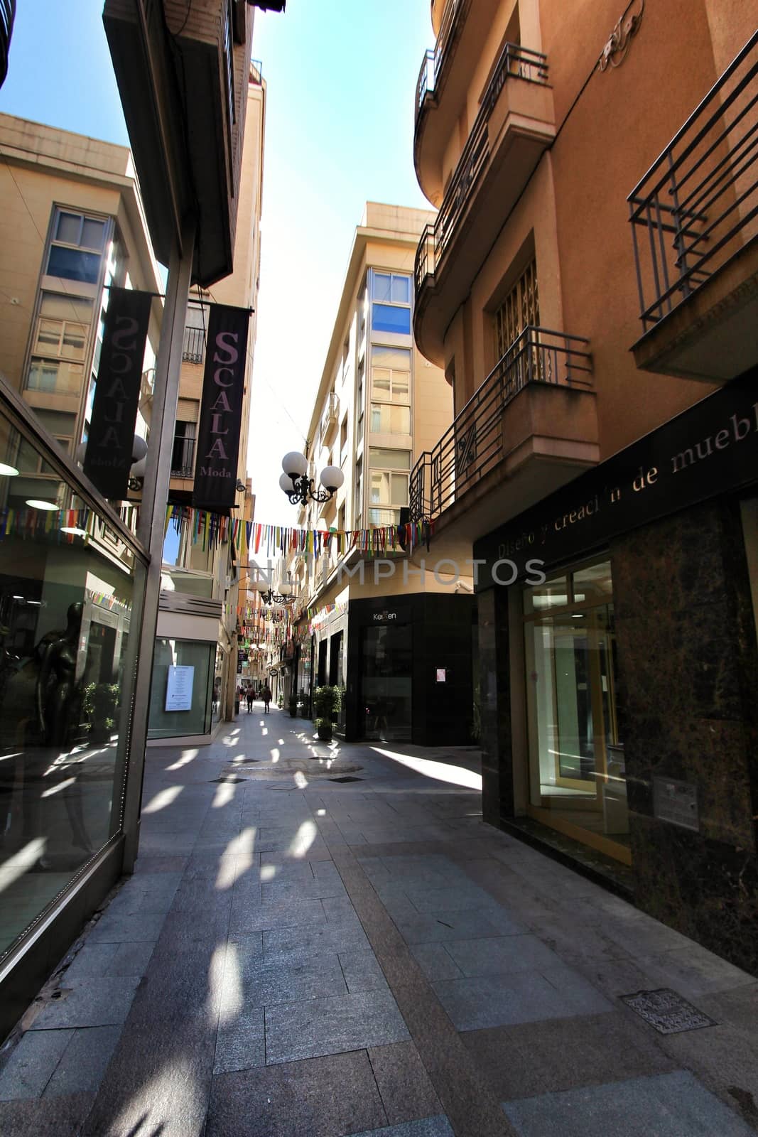 Elche, Alicante, Spain- October 7, 2020: People walking through Pedestrian street plenty of shops called El Salvador in the center of the city of Elche, Alicante province, Spain.