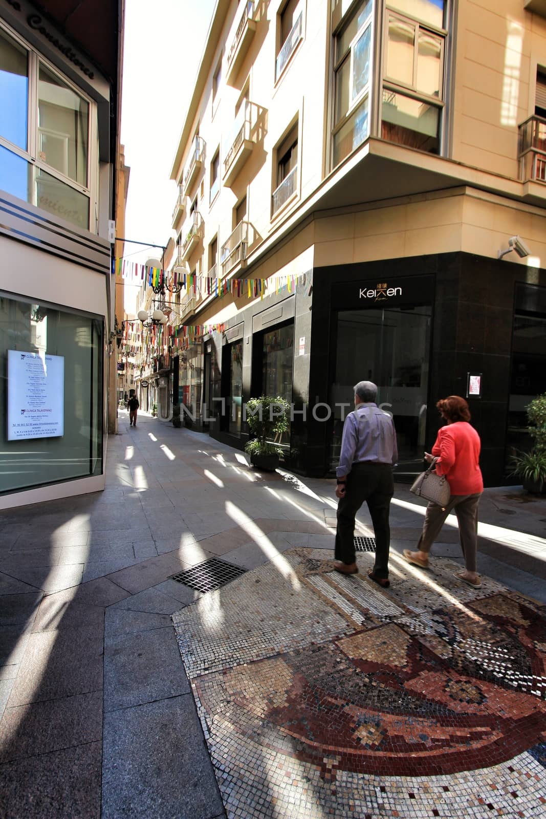 Elche, Alicante, Spain- October 7, 2020: People walking through Pedestrian street plenty of shops called El Salvador in the center of the city of Elche, Alicante province, Spain.