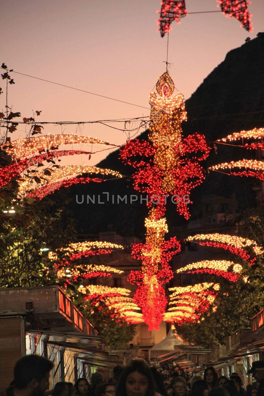Xixona, Alicante, Spain- December 9, 2018: Christmas lighting at the fair of Turron in Jijona, Alicante province, Spain. Crowded streets