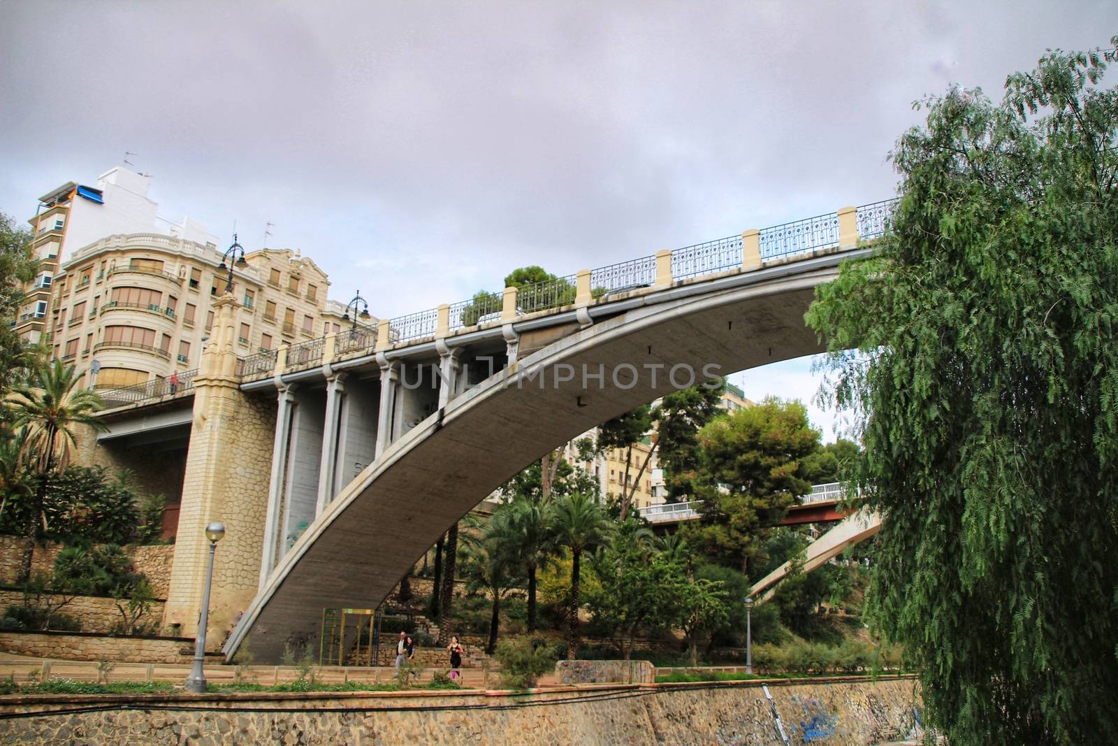 Elche, Alicante, Spain- November 16, 2018 - Landscape of the hillside of the Vinalopo River in Elche with its bridges and green vegetation after a rainy day of Autumn