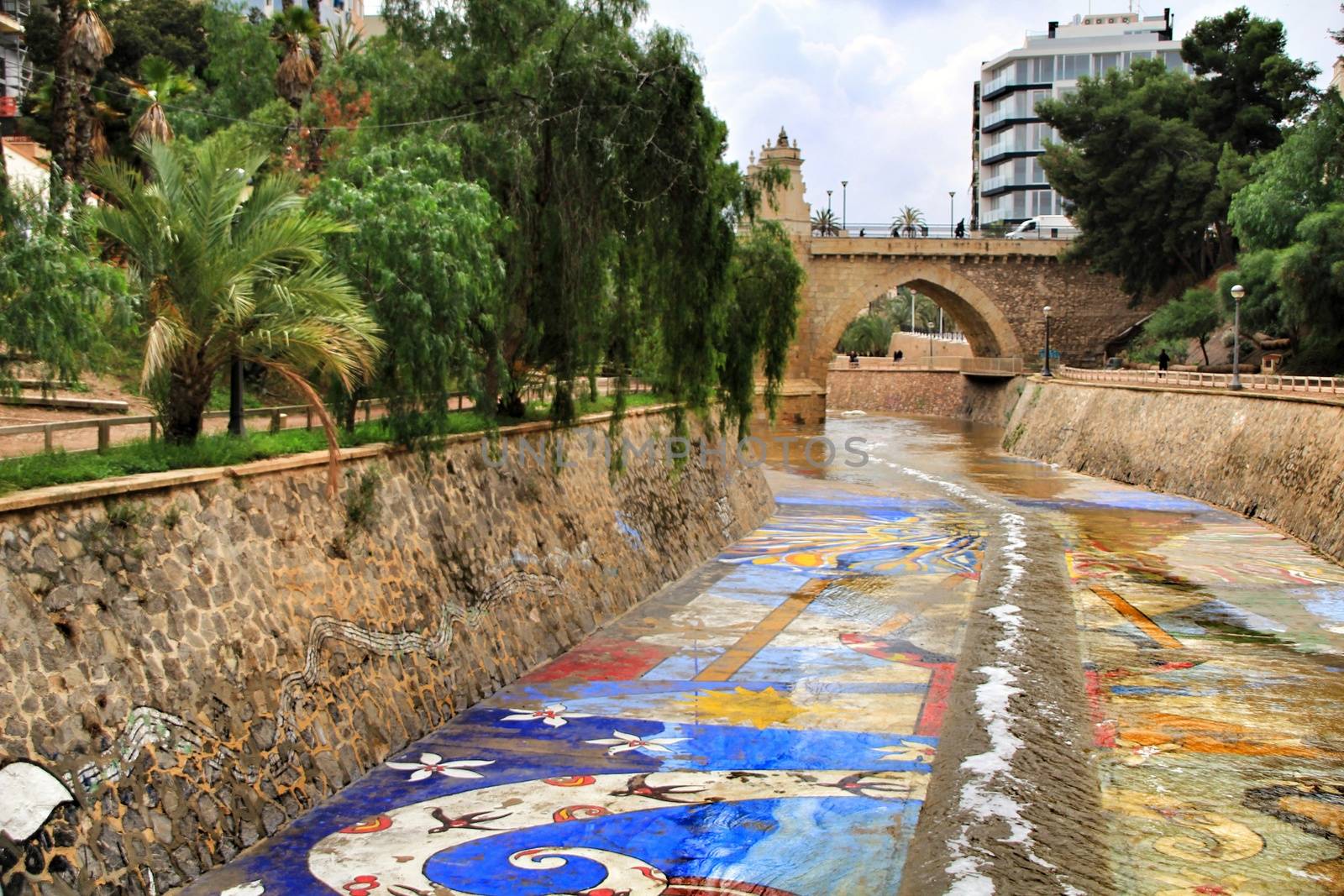 Elche, Alicante, Spain- November 16, 2018 - Landscape of the hillside of the Vinalopo River in Elche with its bridges and green vegetation after a rainy day of Autumn