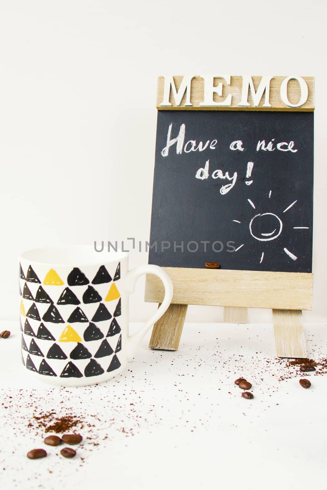 Coffee beans, cup and have a nice day text and letter on the black board, studio shoot ,on the white background by Taidundua