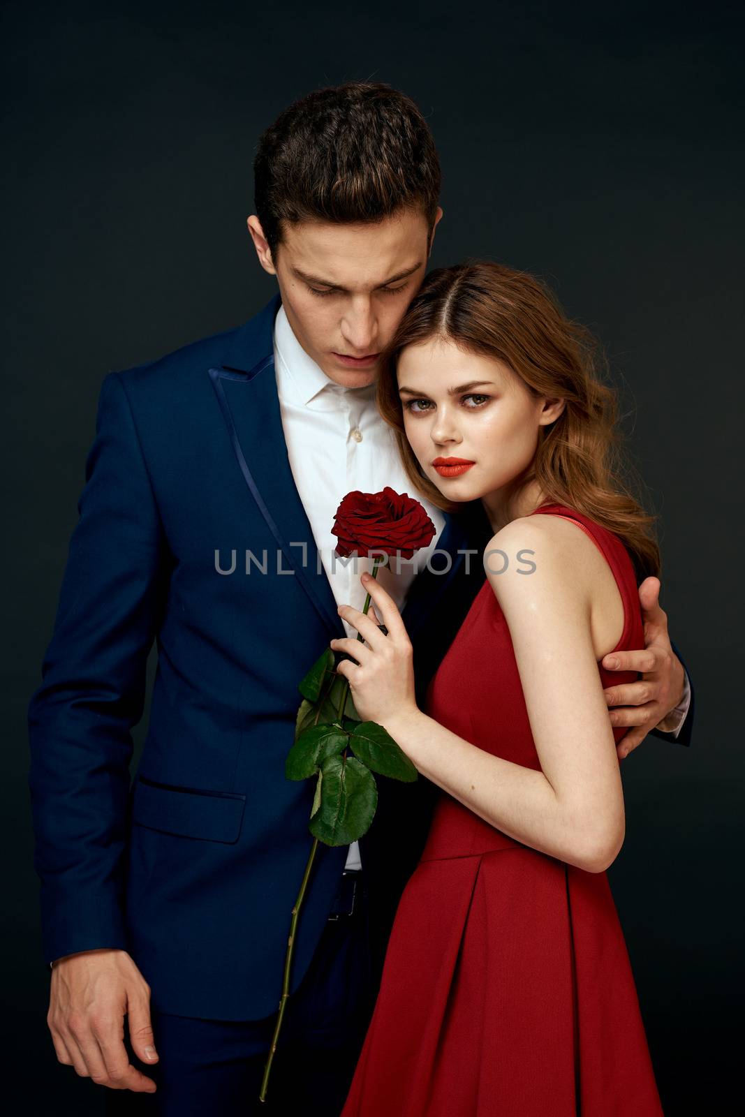 luxury couple hug romance relationship rose over dark isolated background. High quality photo