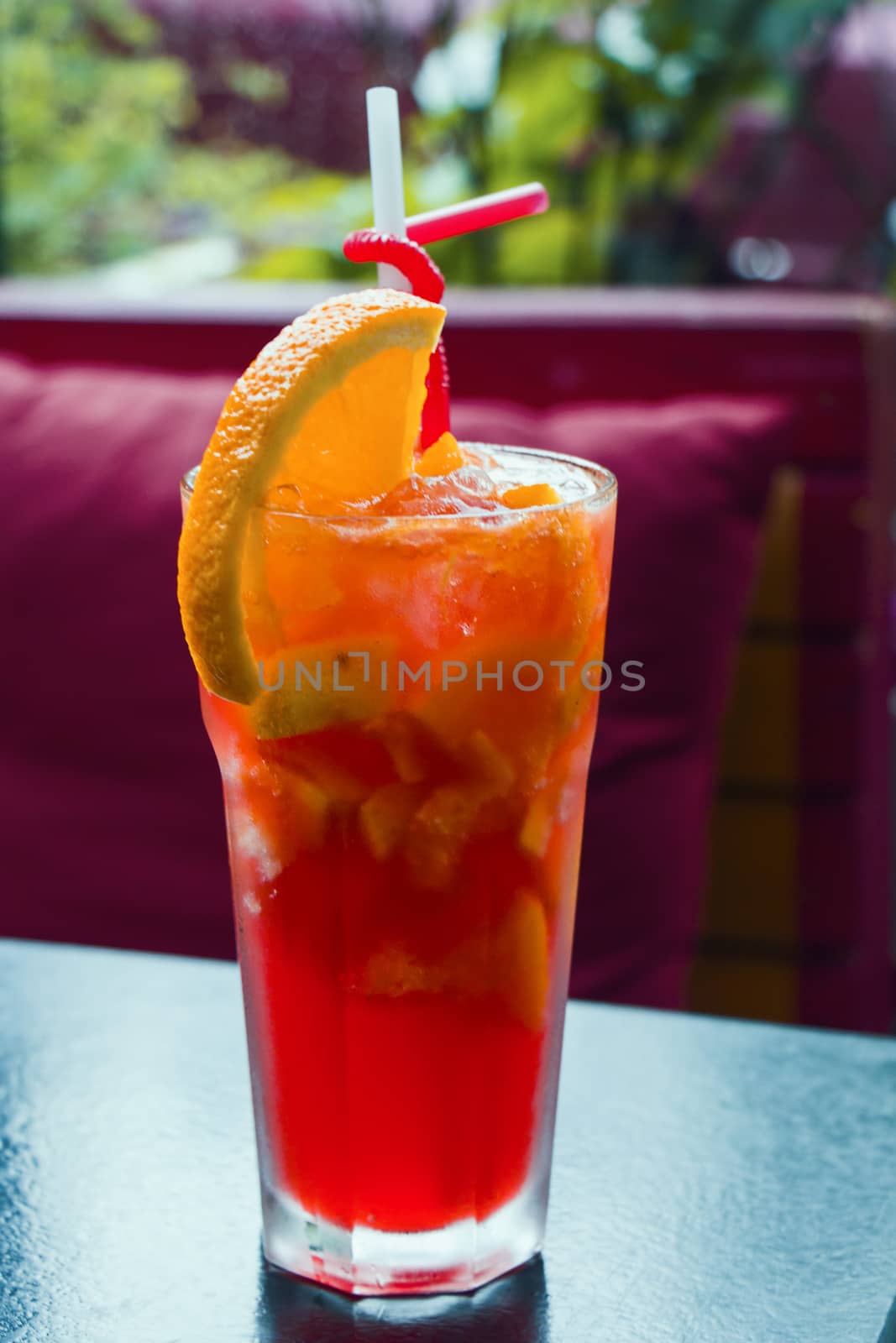 Alcoholic cocktail and lemonade with citruses, orange color cocktail on the table