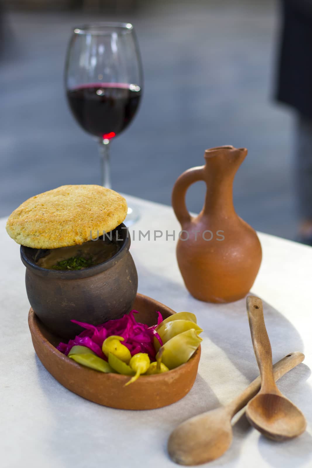 Georgian traditional food Lobio or kidney and haricot beans soup with picked vegetables and red wine. Tbilisi, Georgia.