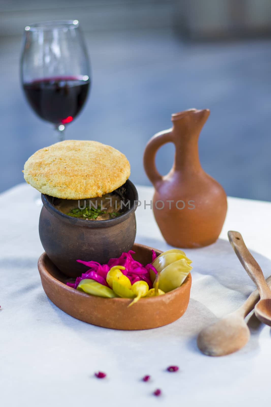 Georgian traditional food Lobio or kidney and haricot beans soup with picked vegetables and red wine. Tbilisi, Georgia.