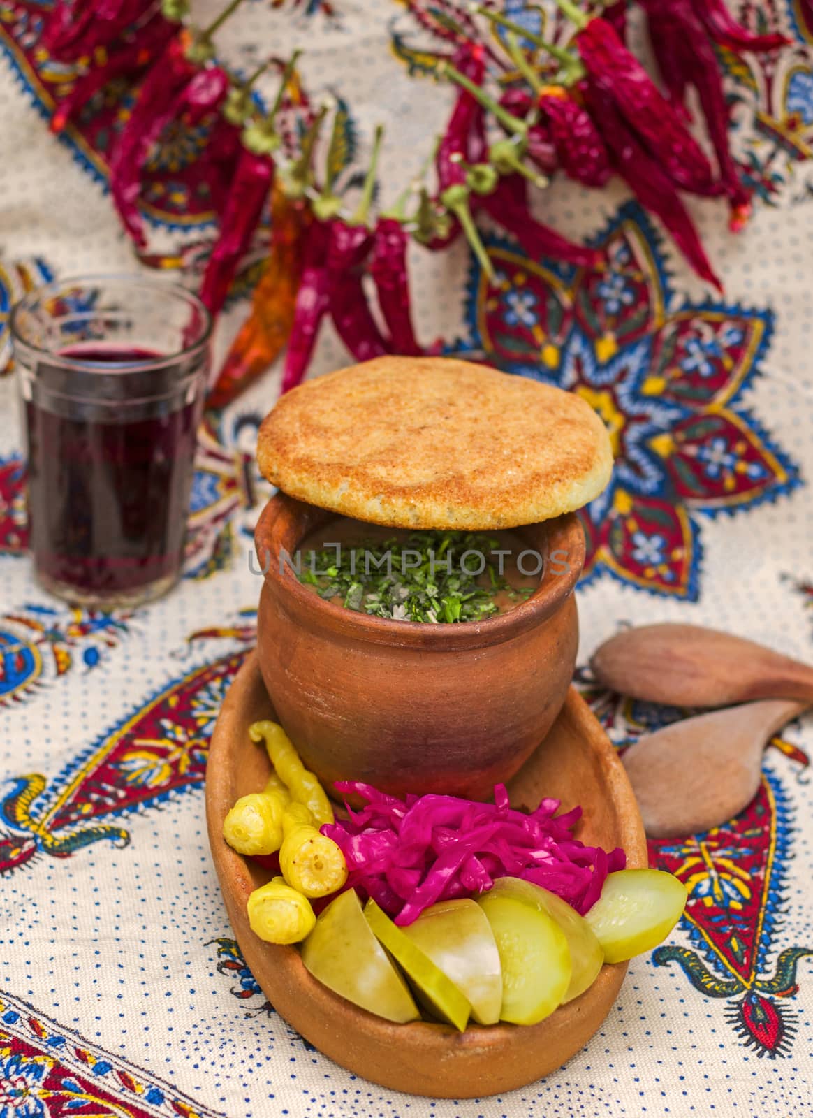 Georgian traditional food Lobio or kidney and haricot beans soup with picked vegetables and red wine. by Taidundua
