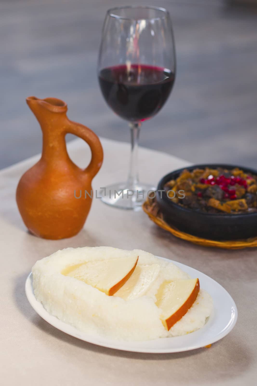 Georgian traditional food ghomi with cheese, wine and kuchmachi. Tbilisi,Georgia.