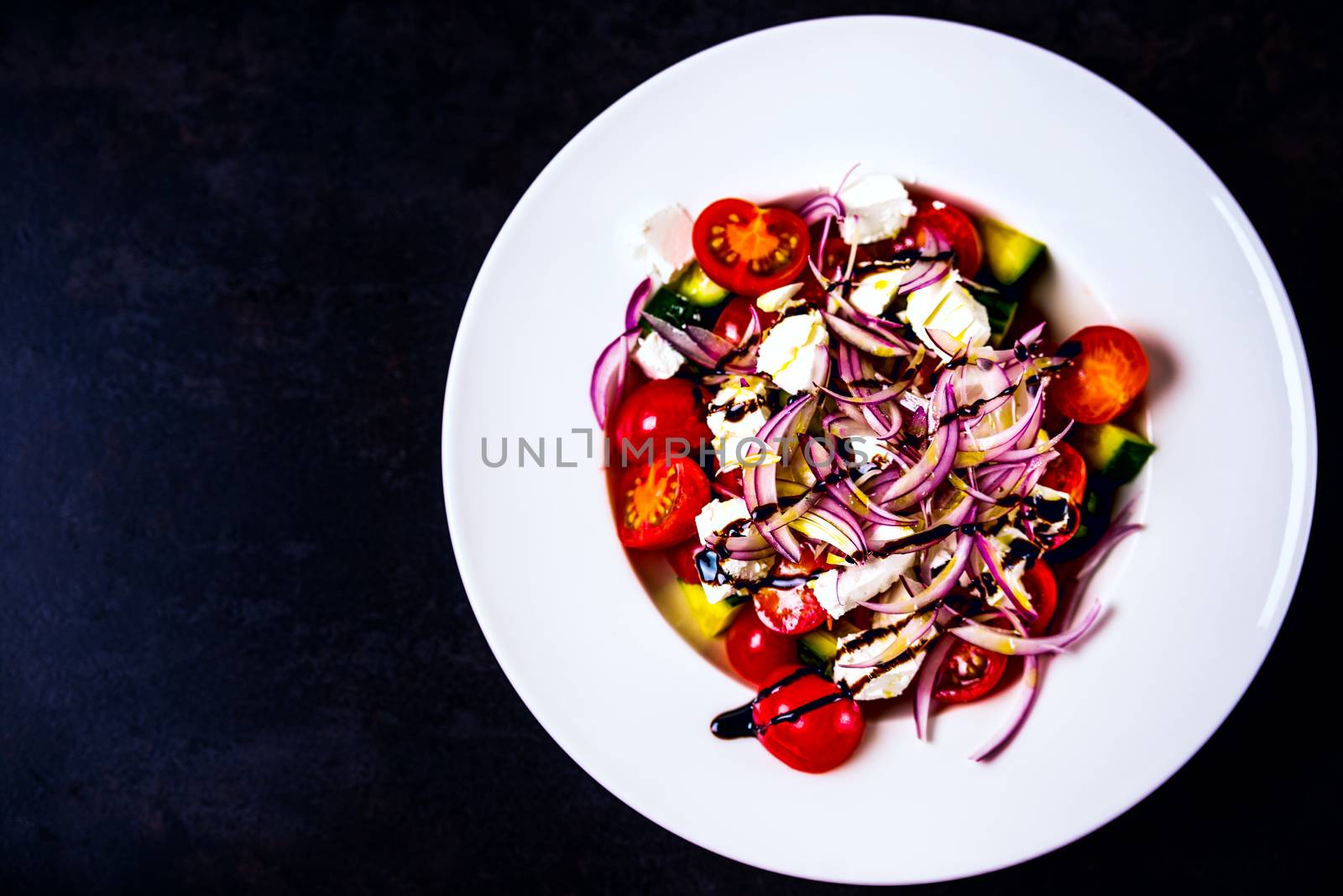 Italian homemade traditional salad with tomato mozzarella onion cucumber