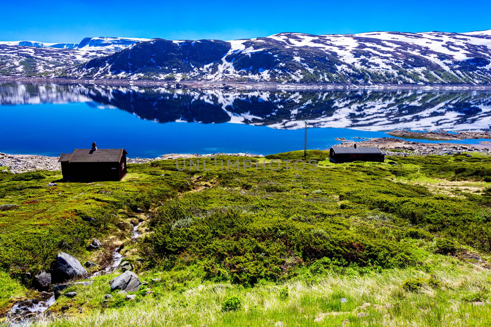 Scenic view on Norwegian landscape with snow mountains at summer