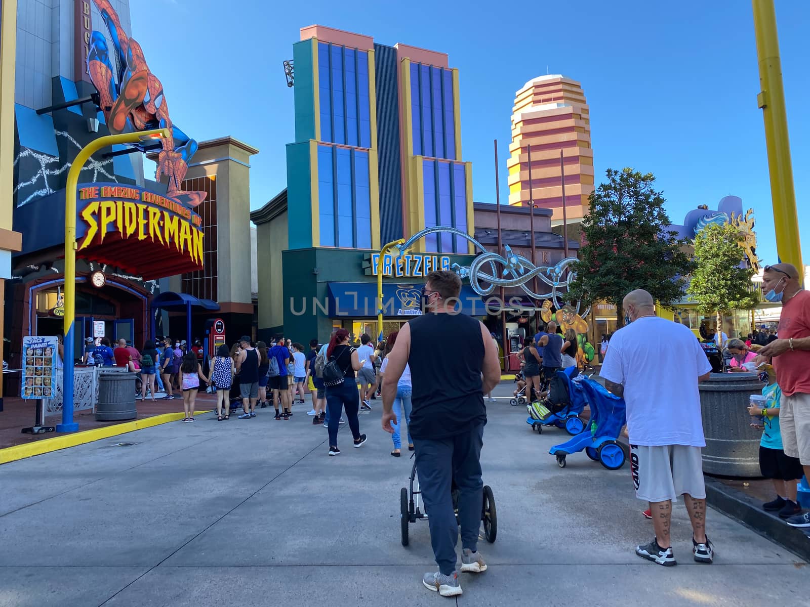 Orlando,FL/USA-10/18/20: People walking  in front of the Marvel area at Universal Studios Resort theme park wearing face masks and social distancing due to the coronavirus pandemic.