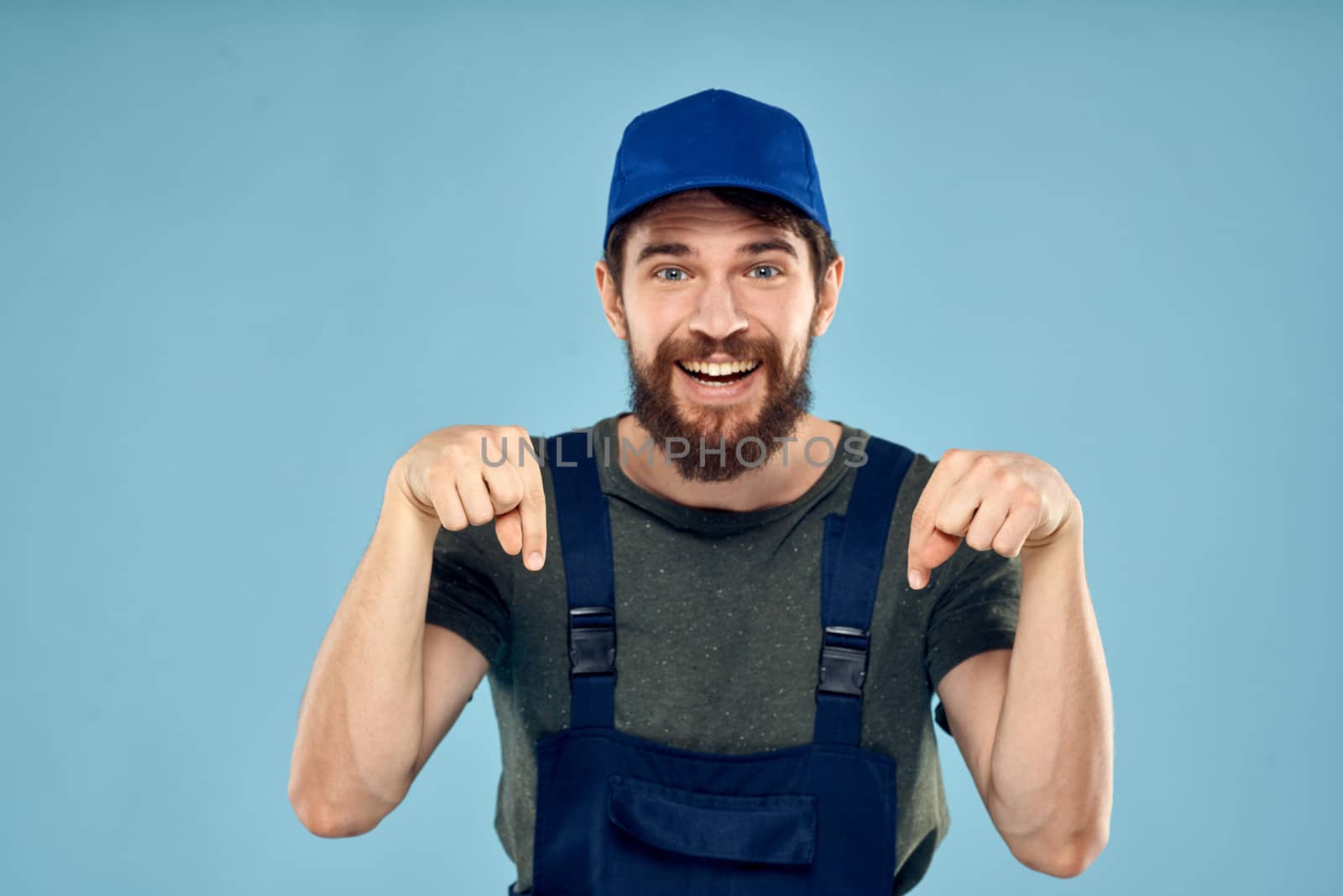 man in work uniform uniform professional work lifestyle delivery service blue background by SHOTPRIME