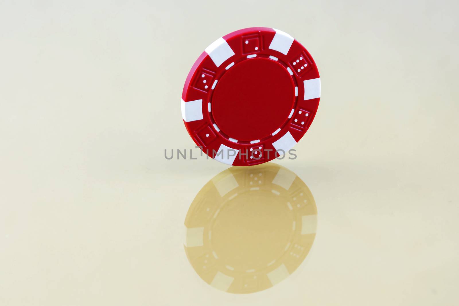 Red casino chip is worth an edge on the reflective surface by Grommik