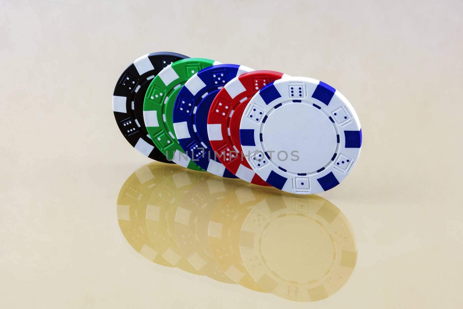 The mirrored surface reflects colorful casino chips by Grommik