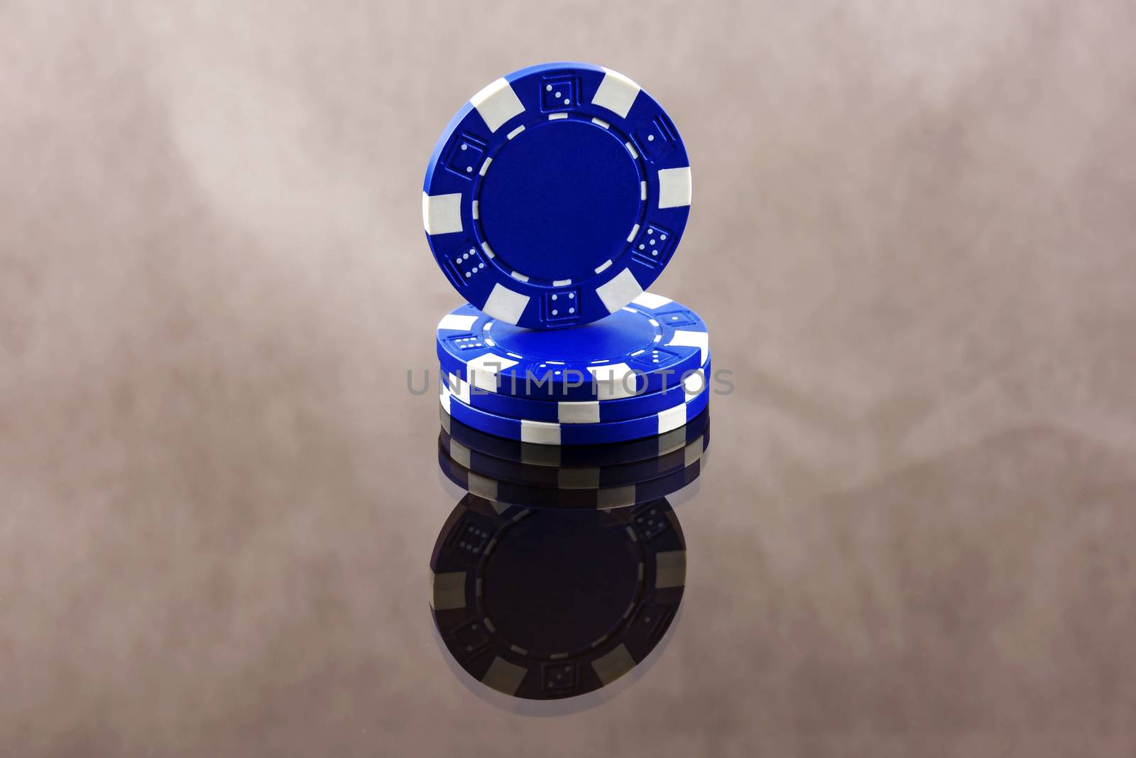 Blue casino chips are reflected in a mirror surface by Grommik