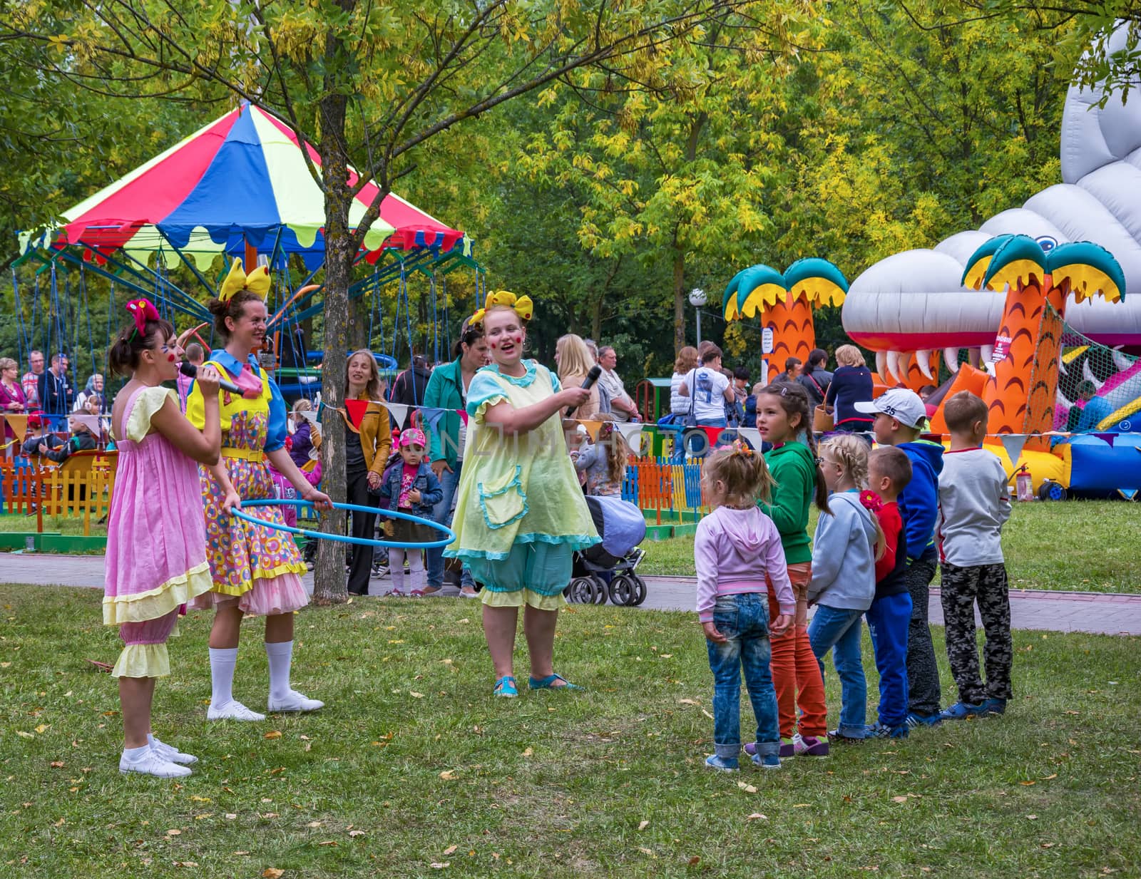 A group of children and disguised women play active outdoor games