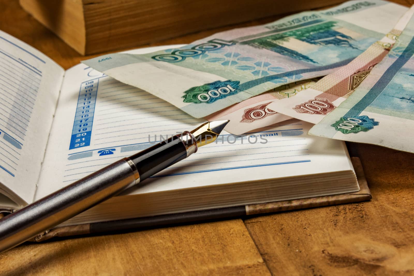 On the open diary page there are several monetary denominations  by Grommik