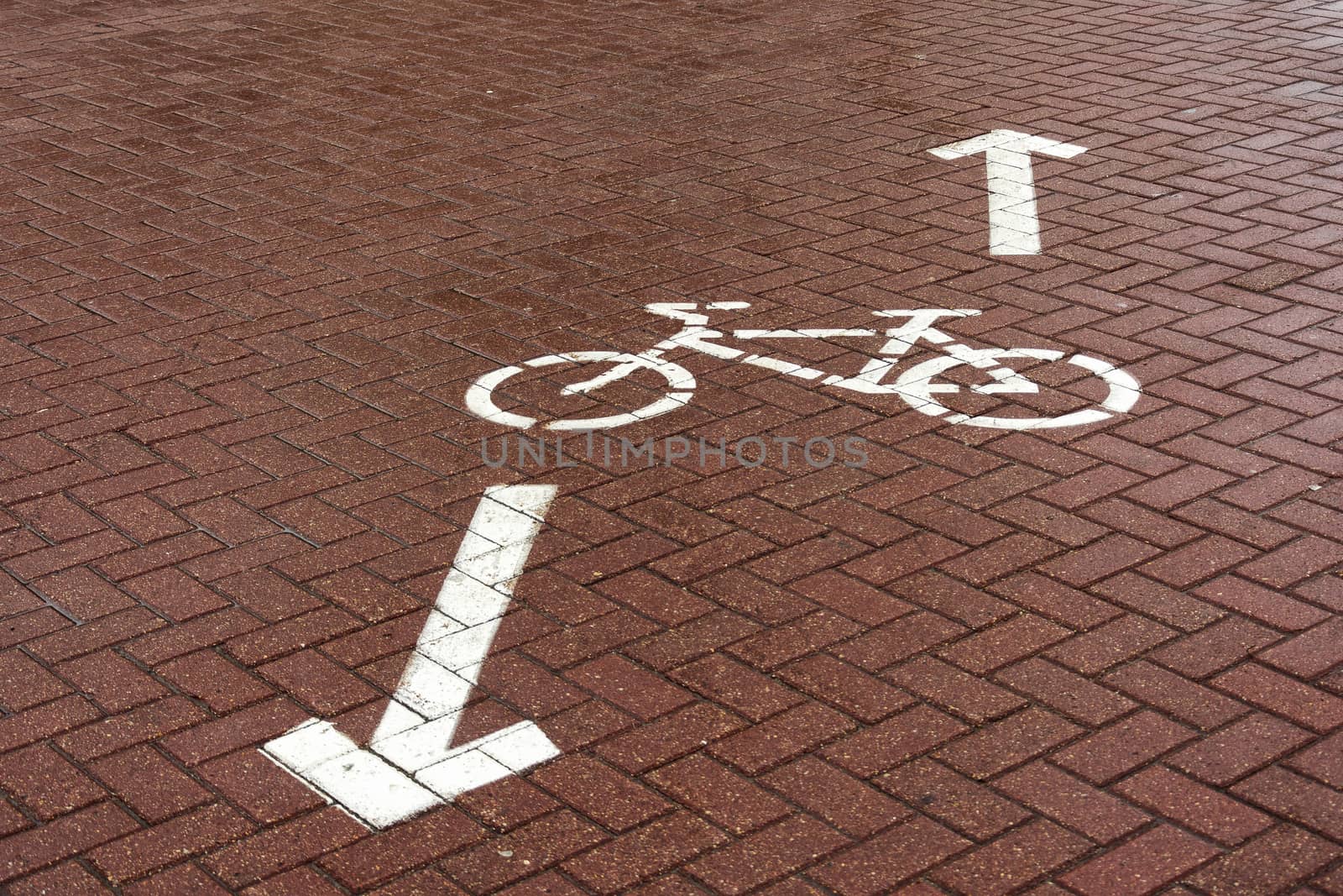 On the paving slab there is a road sign "Bike path"