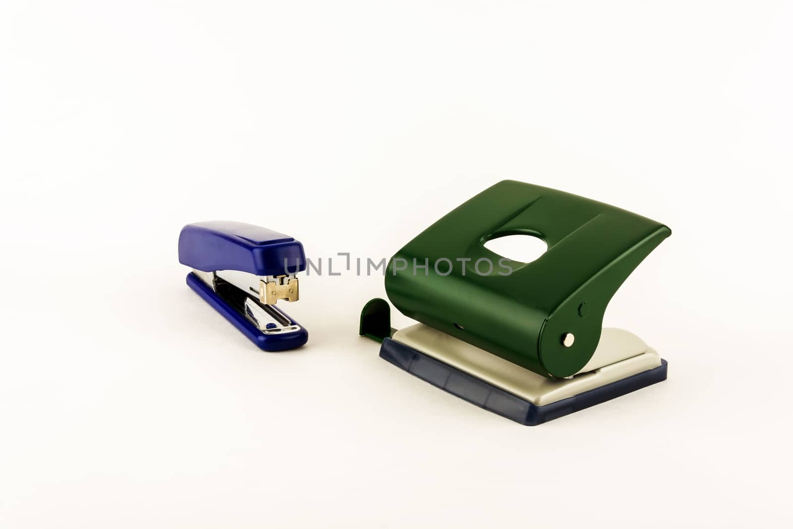 Stationery - punch and stapler on white background by Grommik