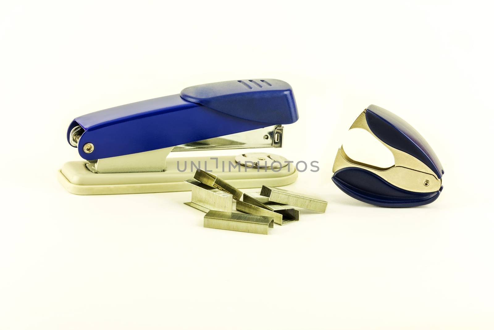 Stapler, staples for stapler and anti-stapler lie on white backg by Grommik