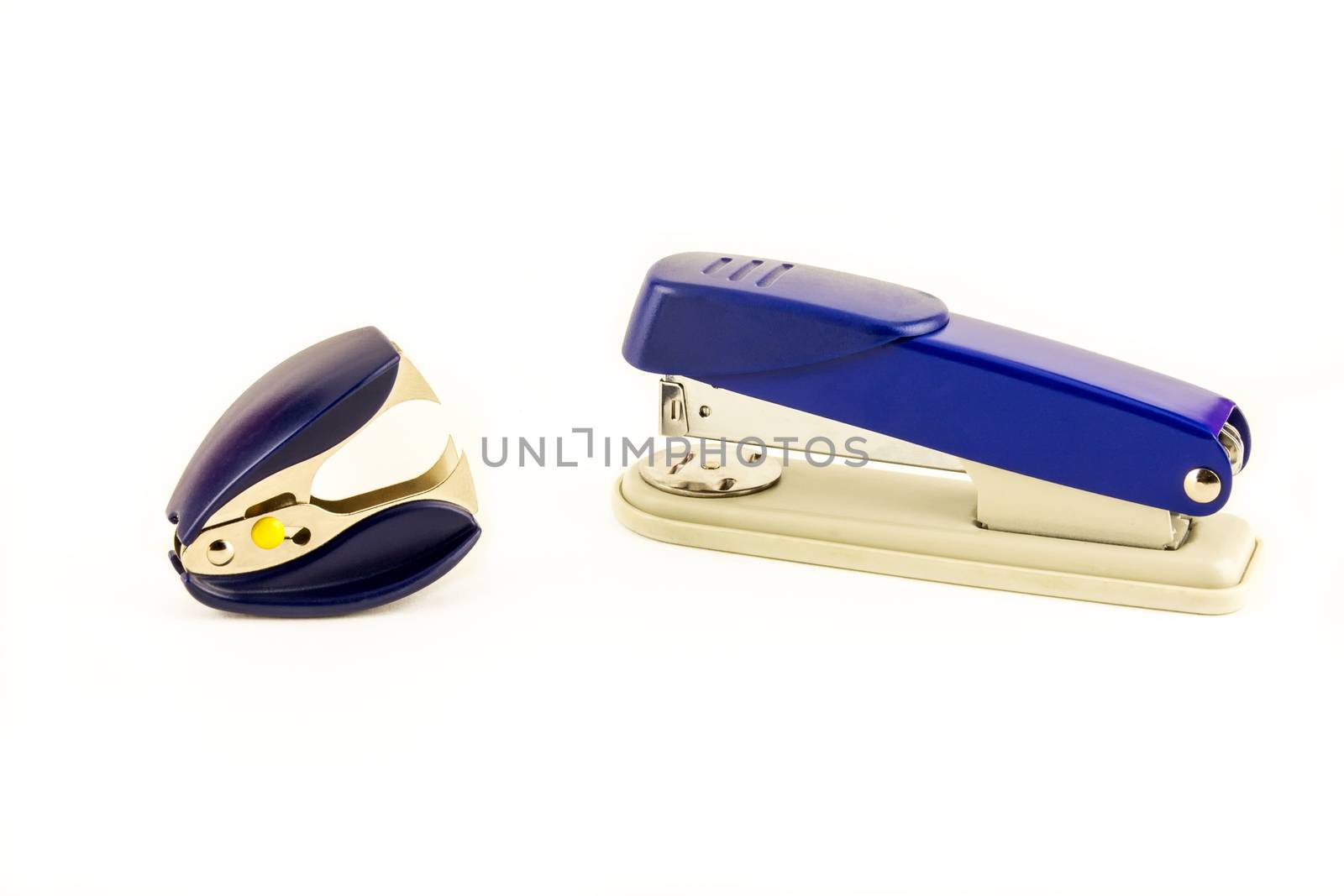 Stapler and anti-stapler lie on white background by Grommik