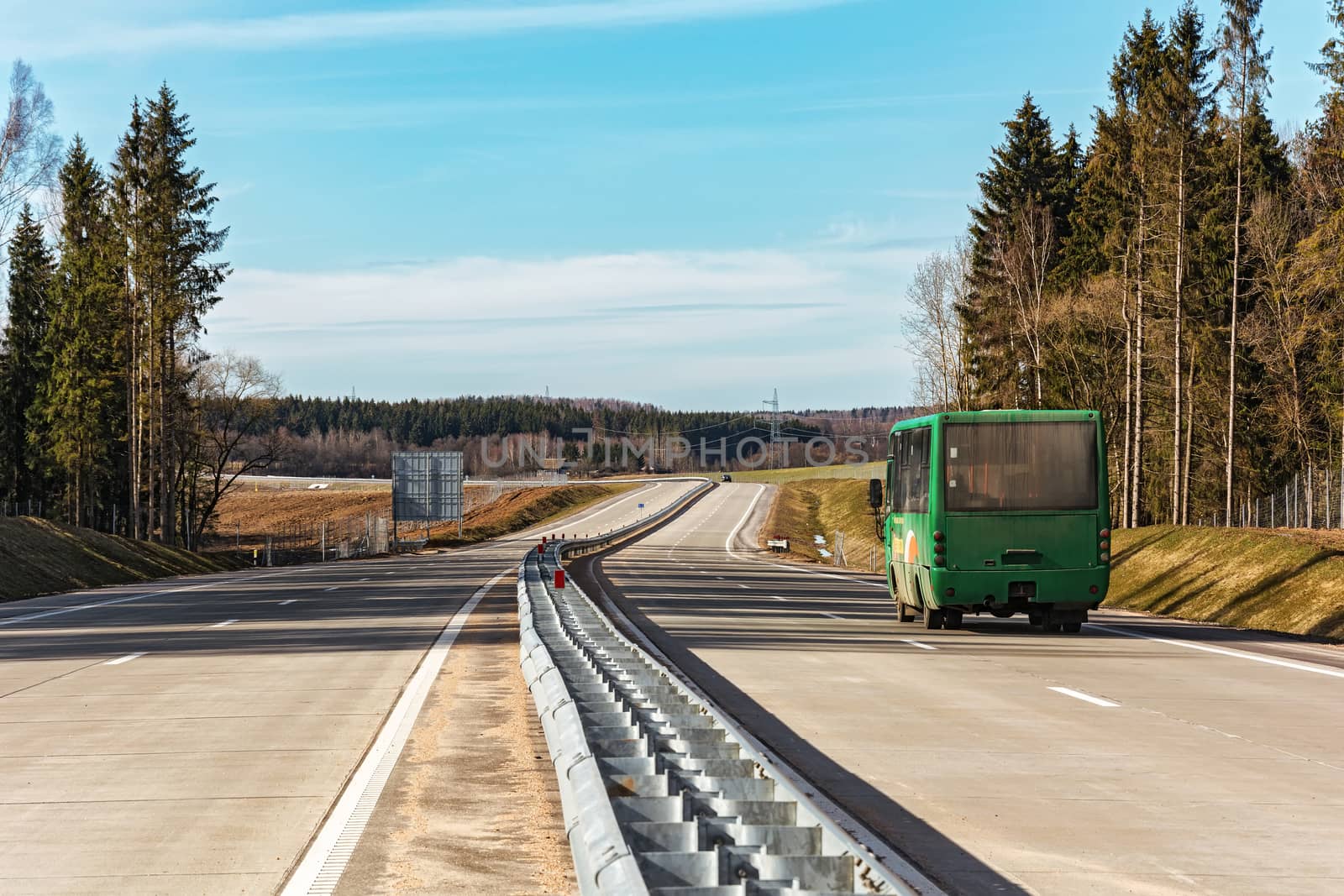 On the road there is a passenger bus by Grommik