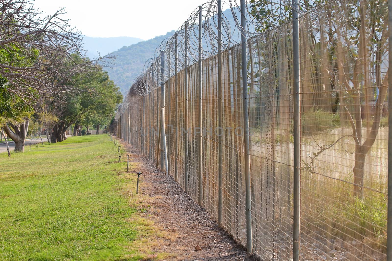 Security perimeter fence surrounding a rural bush encampment, Burgersfort, South Africa