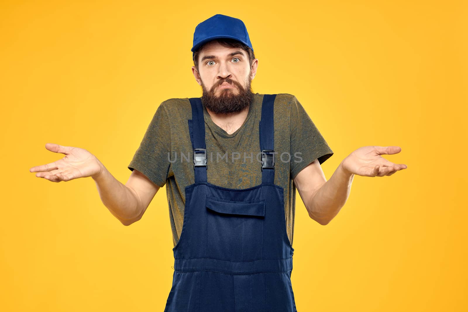 man in work uniform rendering service forklift work lifestyle yellow background. High quality photo