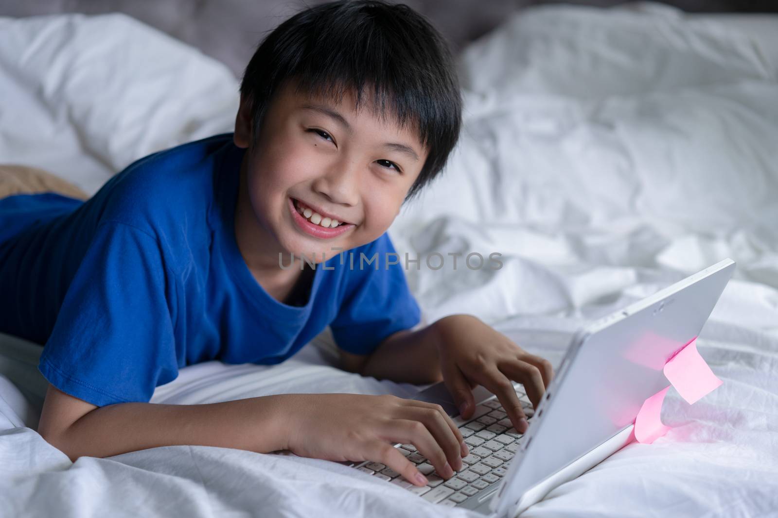 Little boy using laptop learning for education online