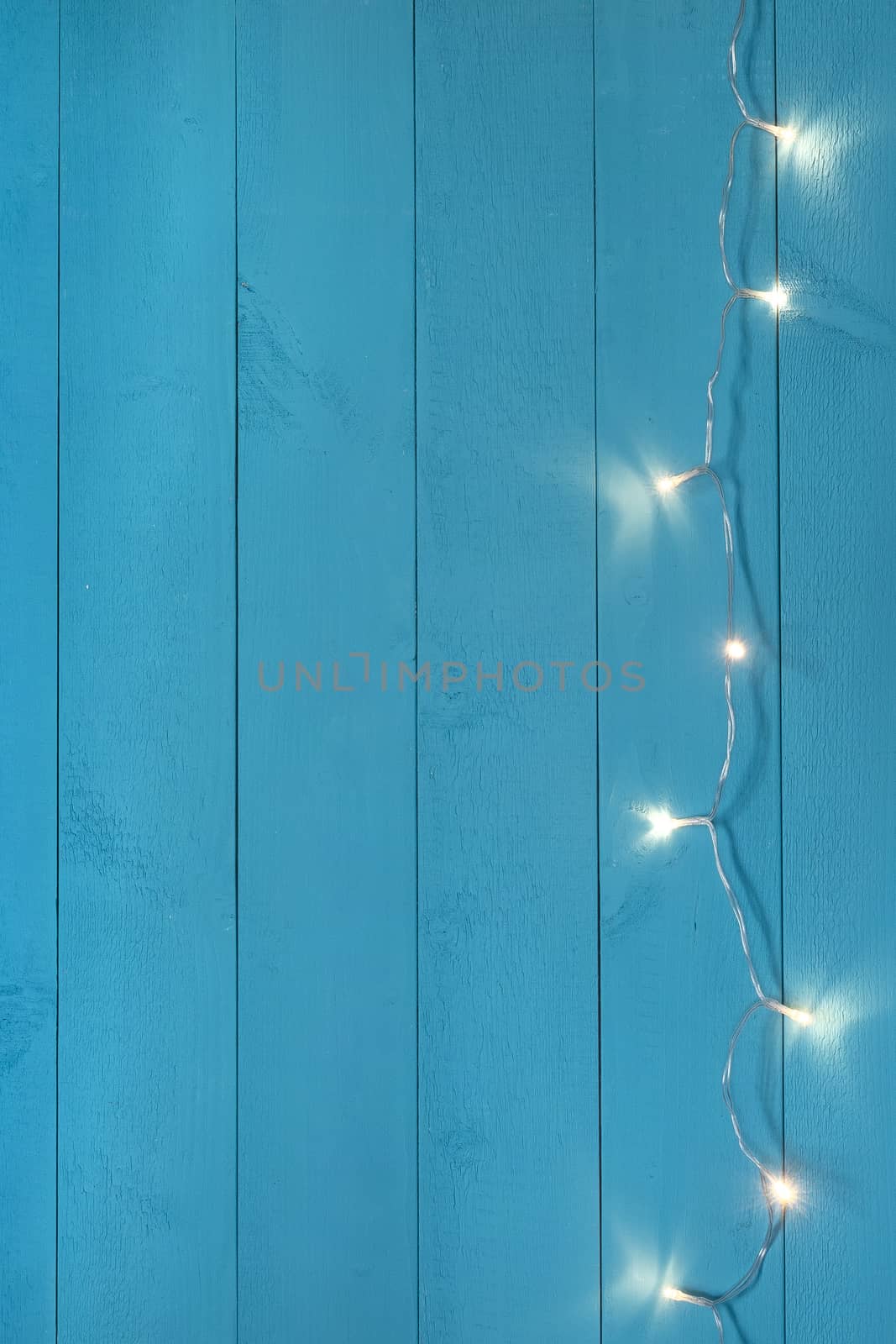 a row of small lights on a blue wooden background