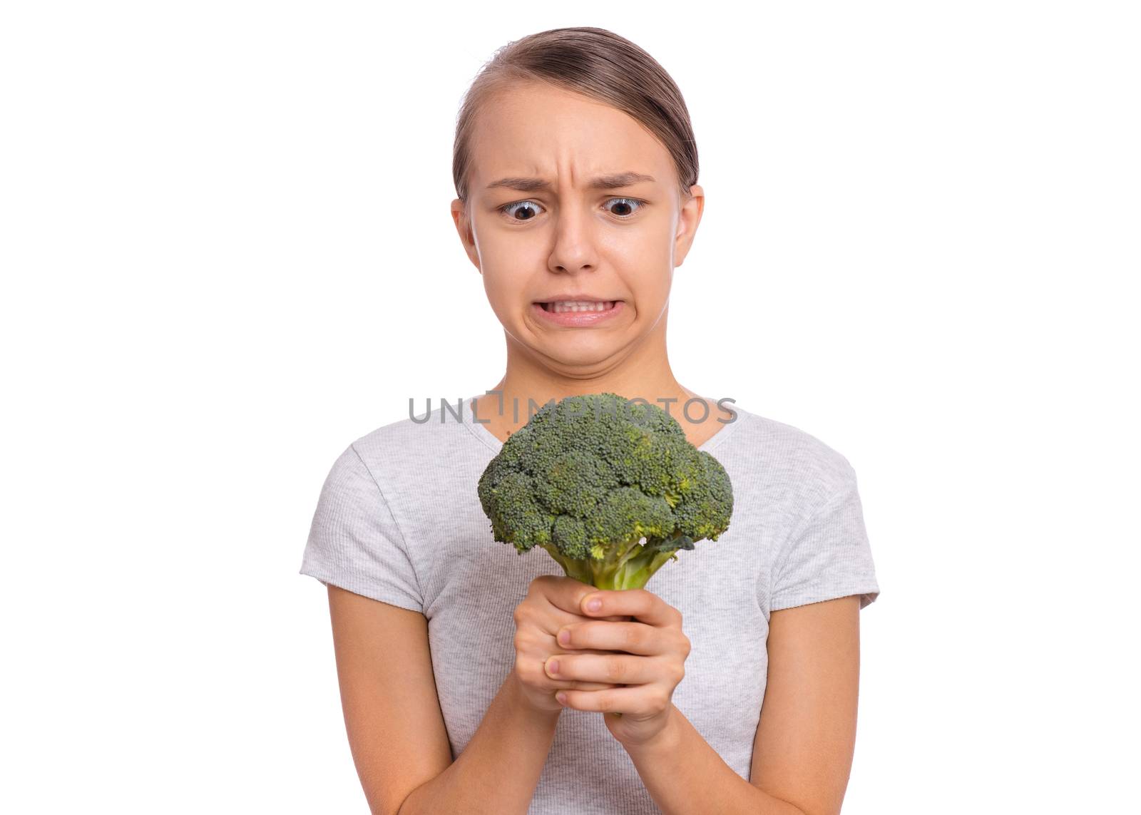 Happy beautiful young teen girl holding perfect product for dieting green broccoli, isolated on white background