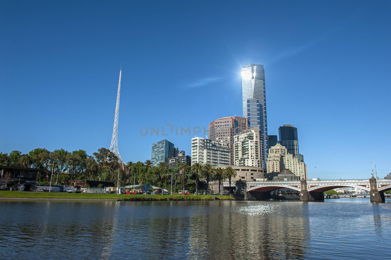 Melbourne skyline with skyscrapers and famous  Melbourne Arts Centre Spire seen across the river Yarra. Victoria, Australia