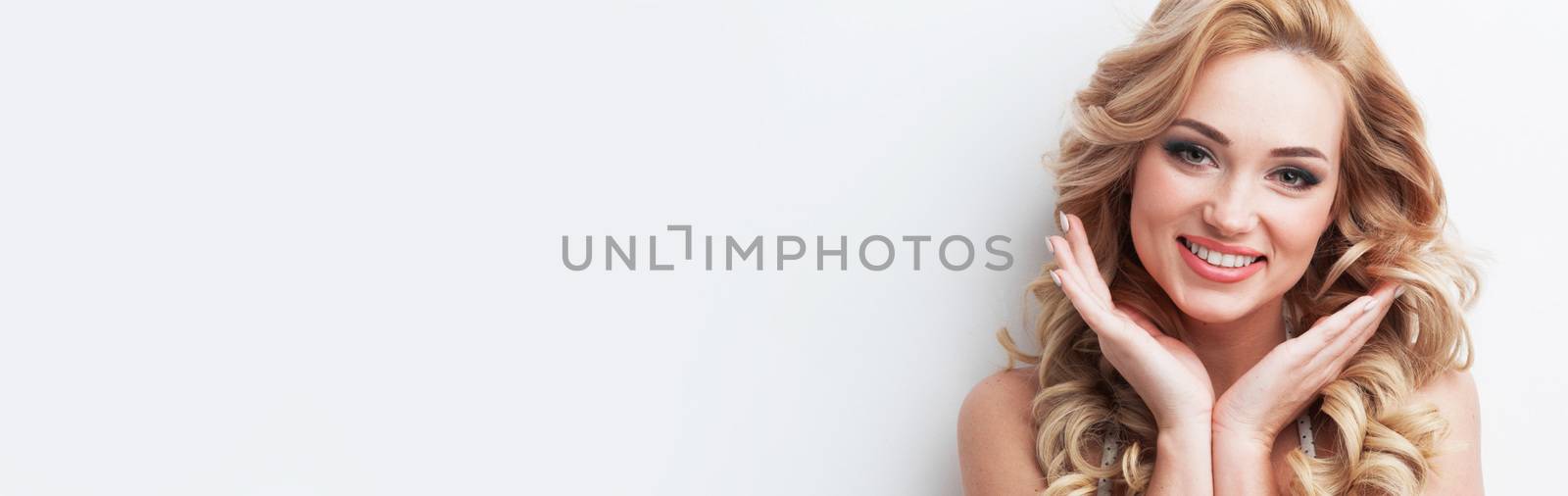 Beautiful smiling blonde woman portrait close up studio on white, face and hands