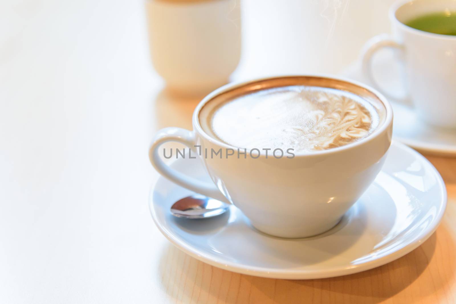 hot coffee on table / hot cappuccino with nice pattern milk foam