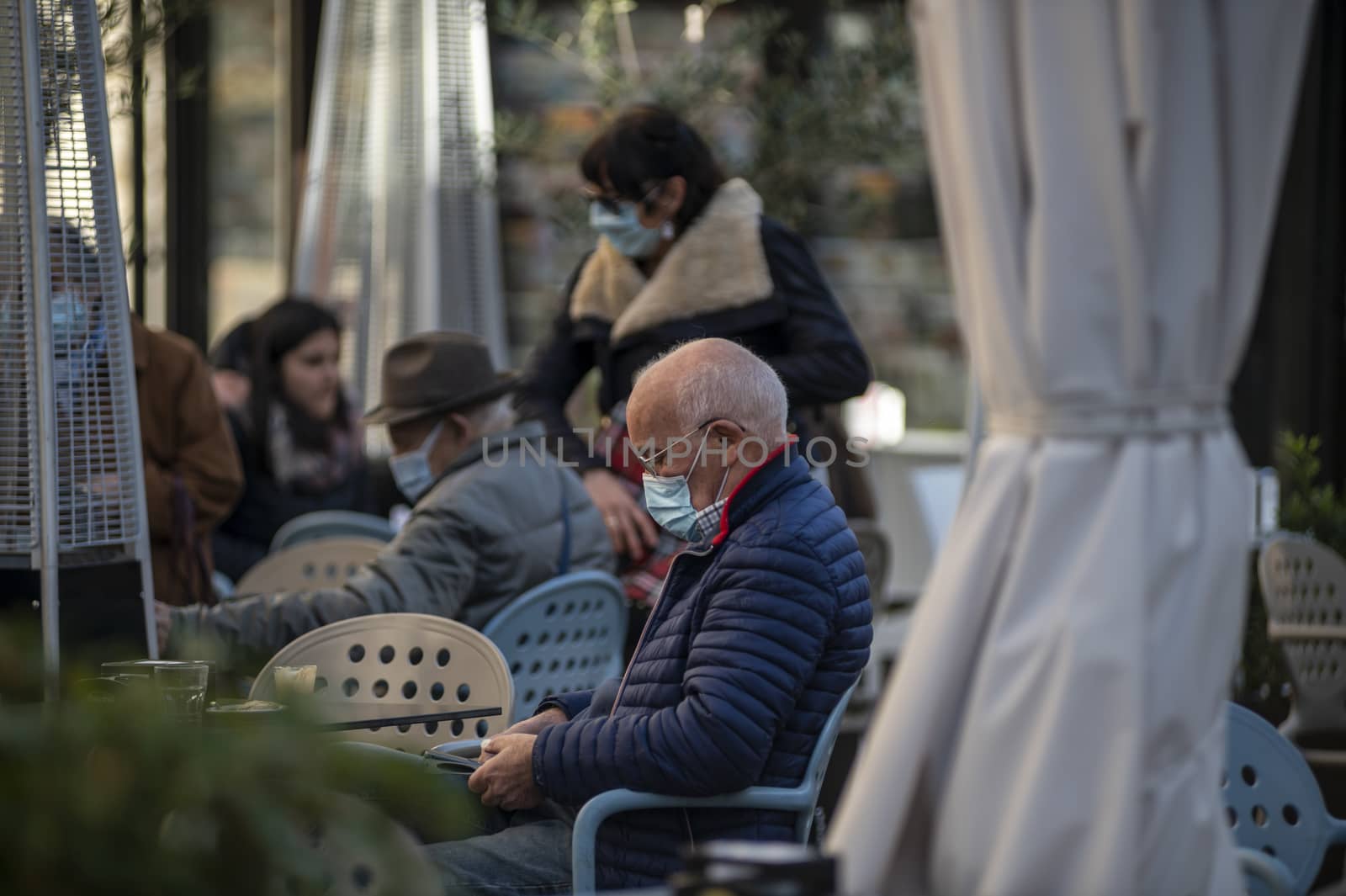 terni,italy october 21 2020:man with medical mask sitting at the cafe in the city center