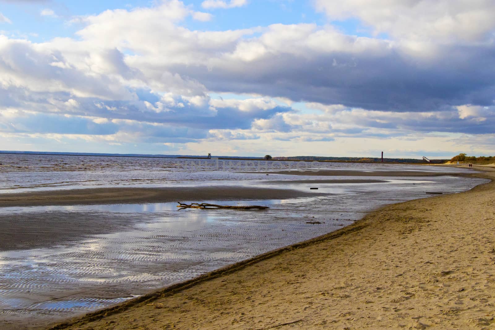Seascape of sea water and beach, sand and clouds , horizon in Estonia.