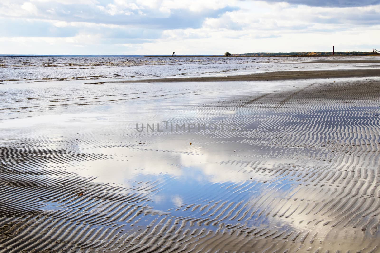 Seascape of sea water and beach, sand and clouds , horizon in Estonia.