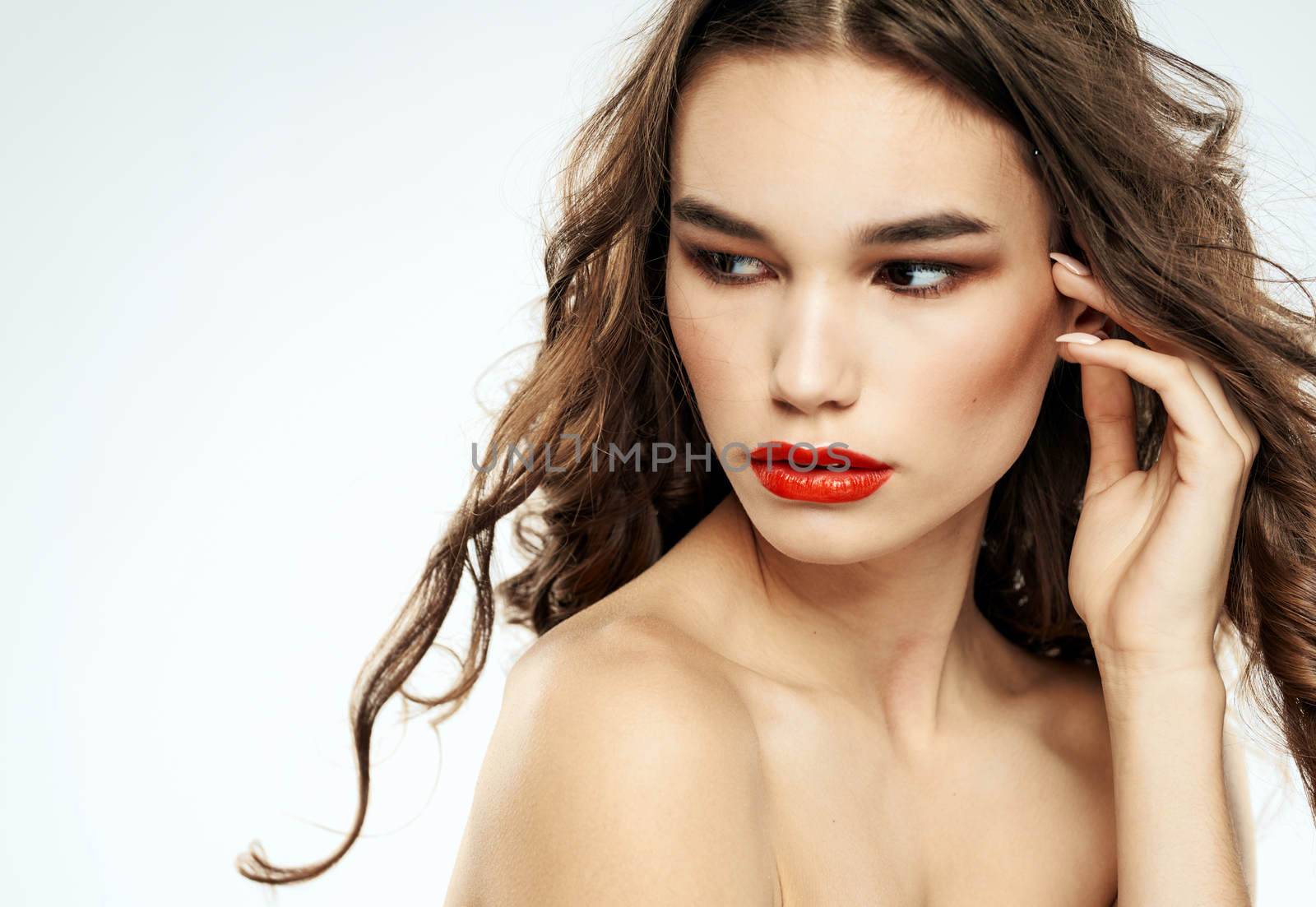 Beautiful lady red lips curly hair makeup portrait. High quality photo