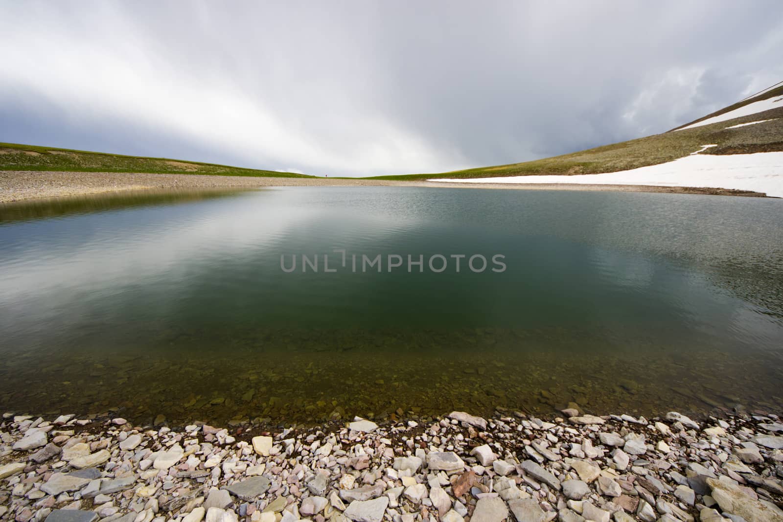 Alpine mountain lake landscape and view, snow and clouds in Javakheti, Georgia