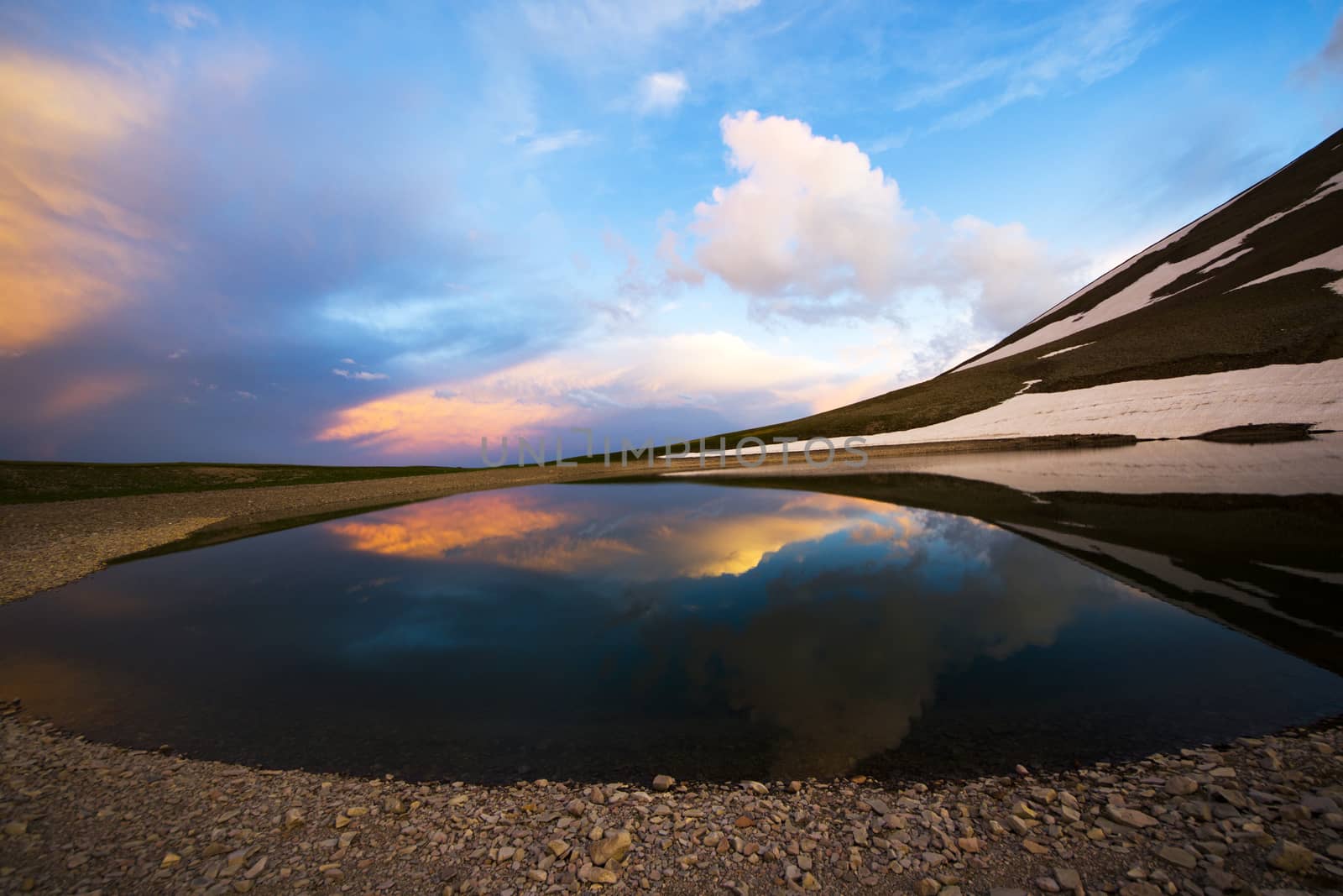 Alpine mountain lake landscape and view, snow and clouds in Javakheti, Georgia