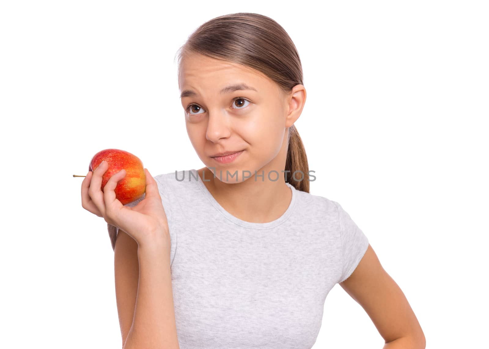 Happy beautiful young teen girl holds apple, isolated on white background
