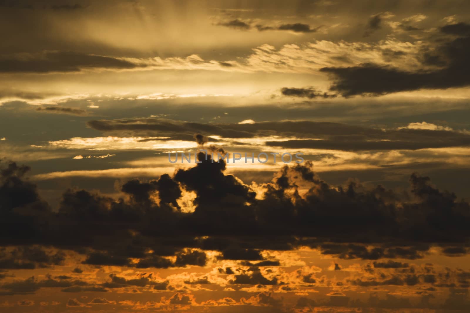 Sunset colored sky, blue, yellow, orange and red, mixed colors,shadows and lights, in Europe